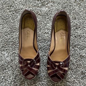 Burgundy open toe Coke Hann shoe.